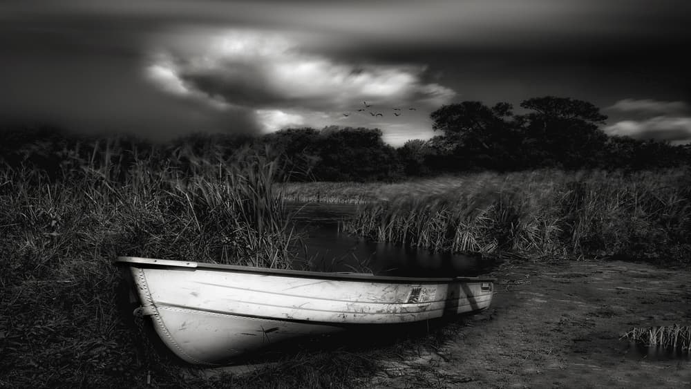 Lonely Boat Under Dark Sky by Yvette Depaepe — canvas wall art