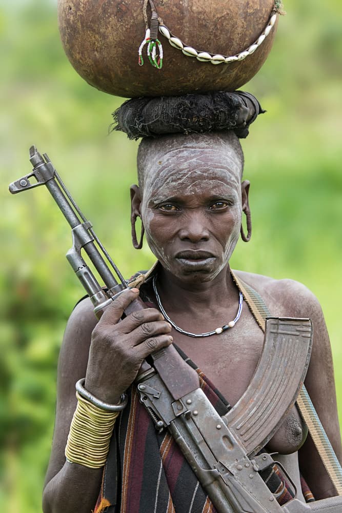 Tribal Woman With Rifle by Amnon Eichelberg — canvas wall art