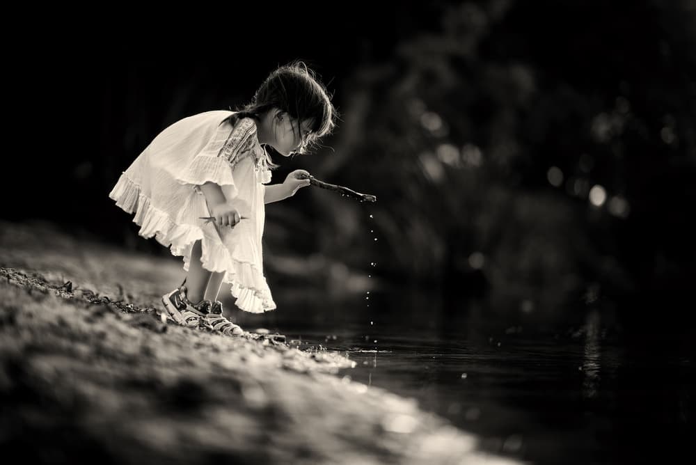 Curious Girl Water Play by Despird Zhang — canvas wall art