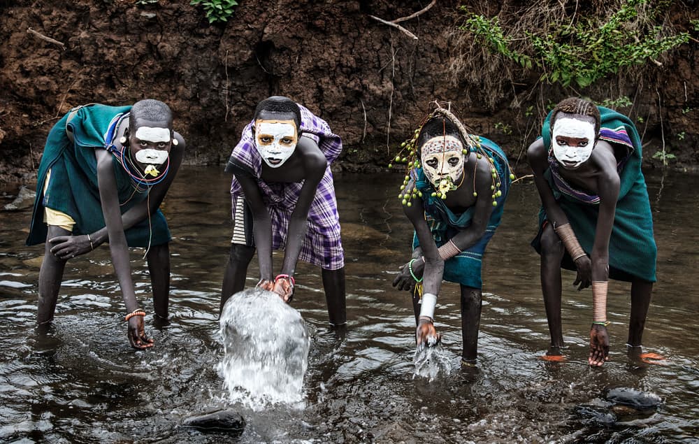 African Youth Water Play by Joxe Inazio Kuesta Garmendia — canvas wall art