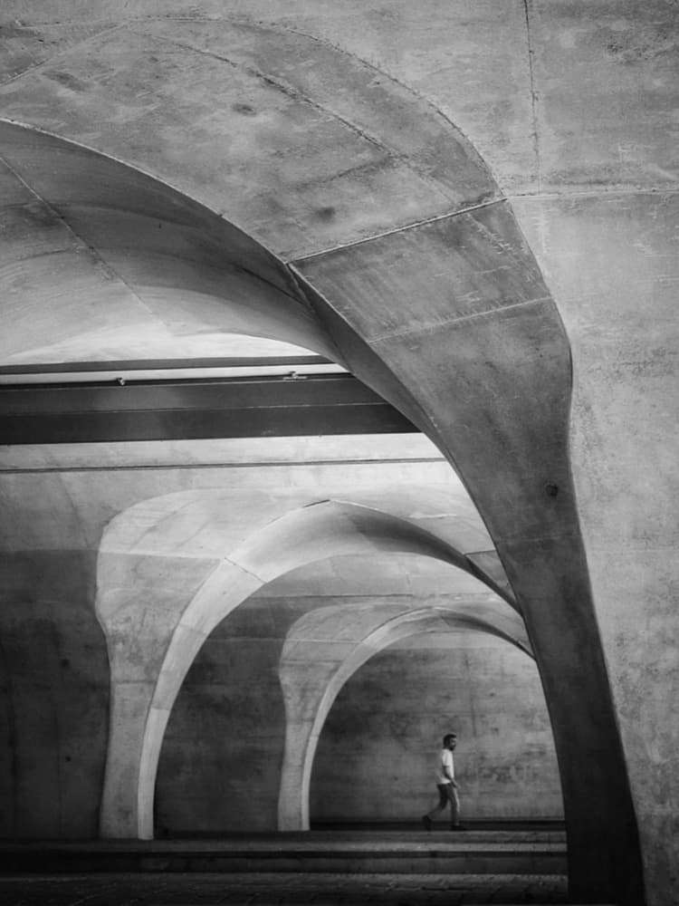 Man Under Concrete Arches by Frank Bruynseraede — canvas wall art