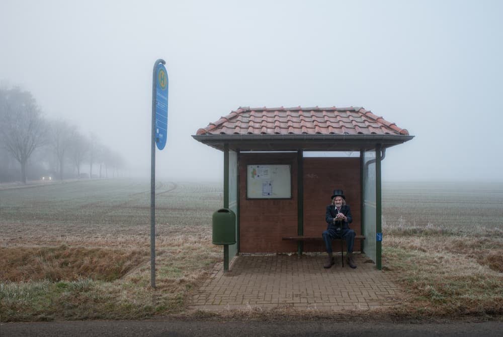 Man at Foggy Bus Stop by Hans Günther — canvas wall art