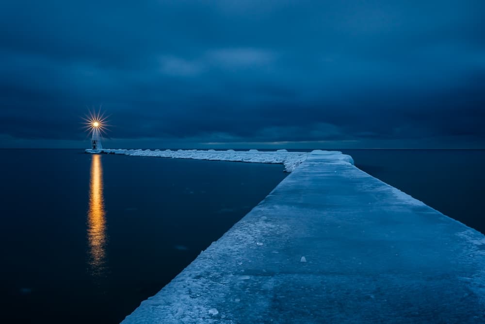 Frozen Pier Lighthouse Glow by John Fan — canvas wall art