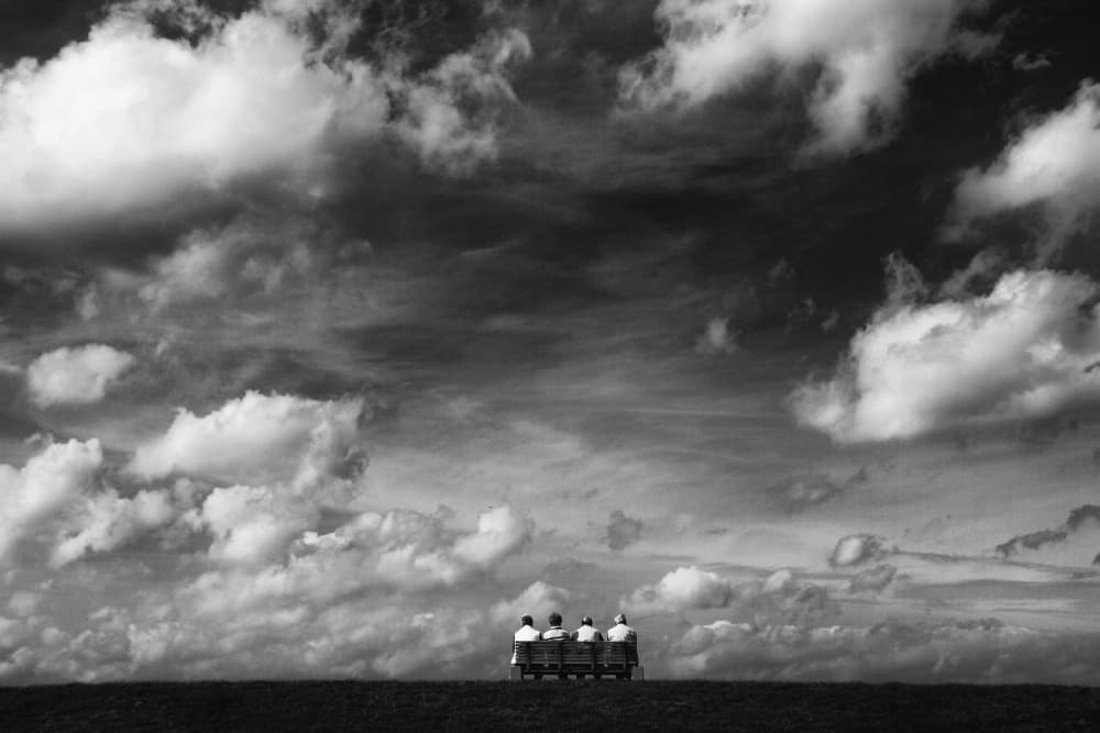 Bench Under Dramatic Sky by Hans-Wolfgang Hawerkamp — canvas wall art
