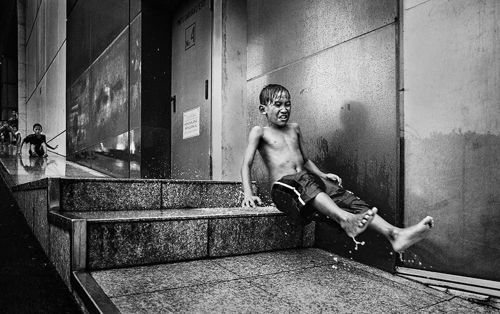 Boy's Wet City Slide by Sebastian Kisworo — canvas wall art