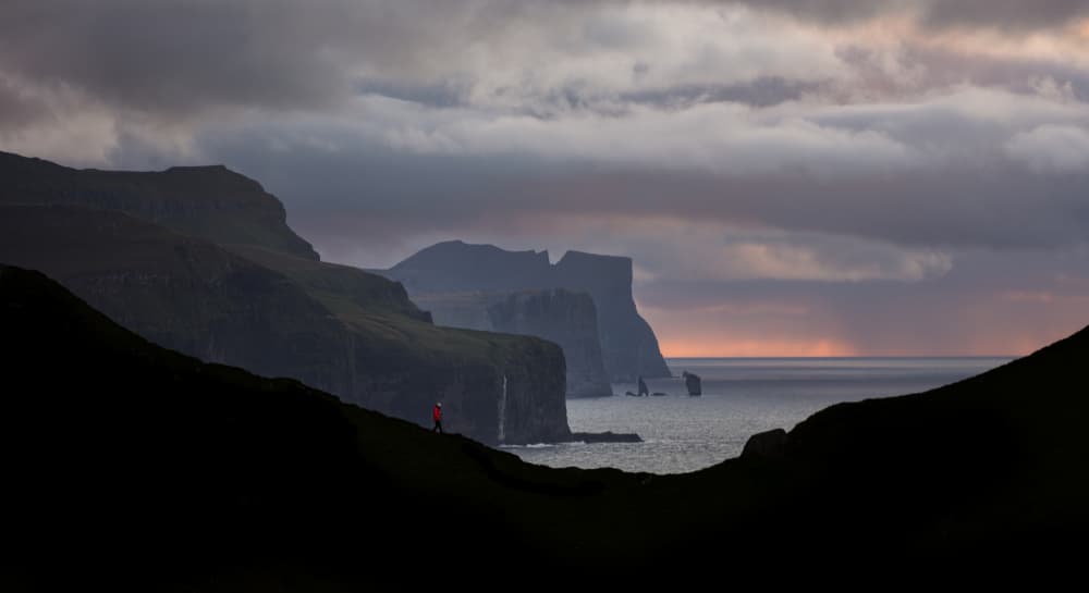 Lone Hiker Epic Cliffs by April Xie — canvas wall art