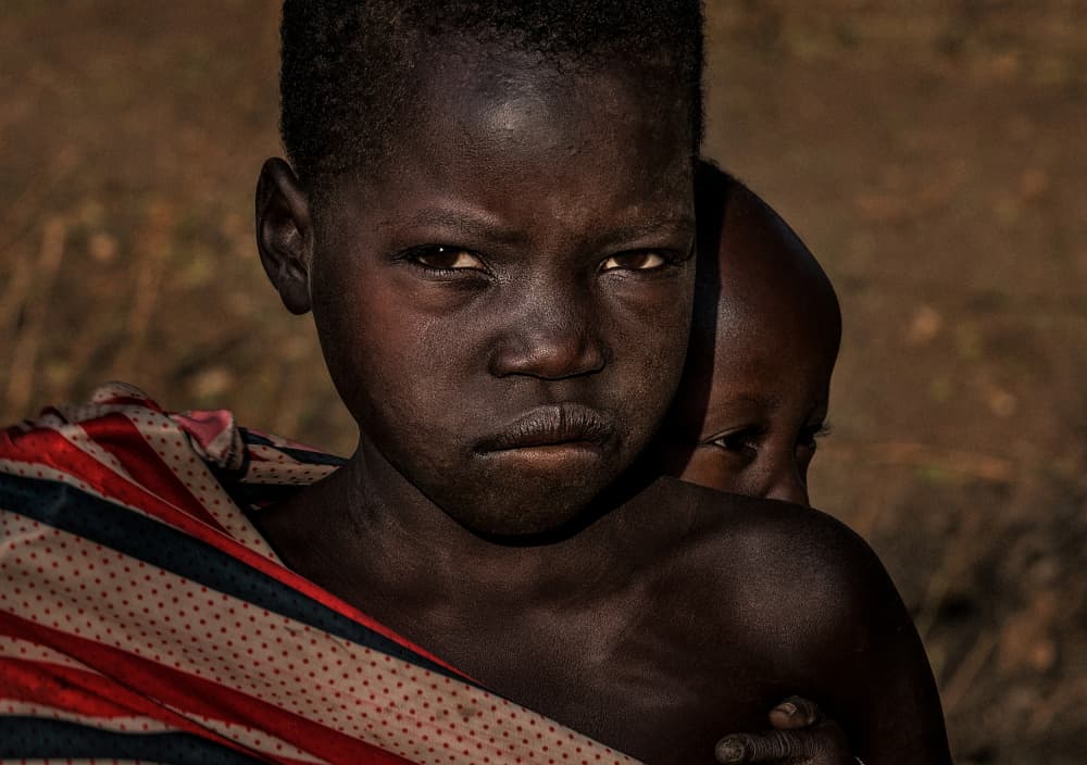 Children's Somber Gaze by Joxe Inazio Kuesta Garmendia — canvas wall art