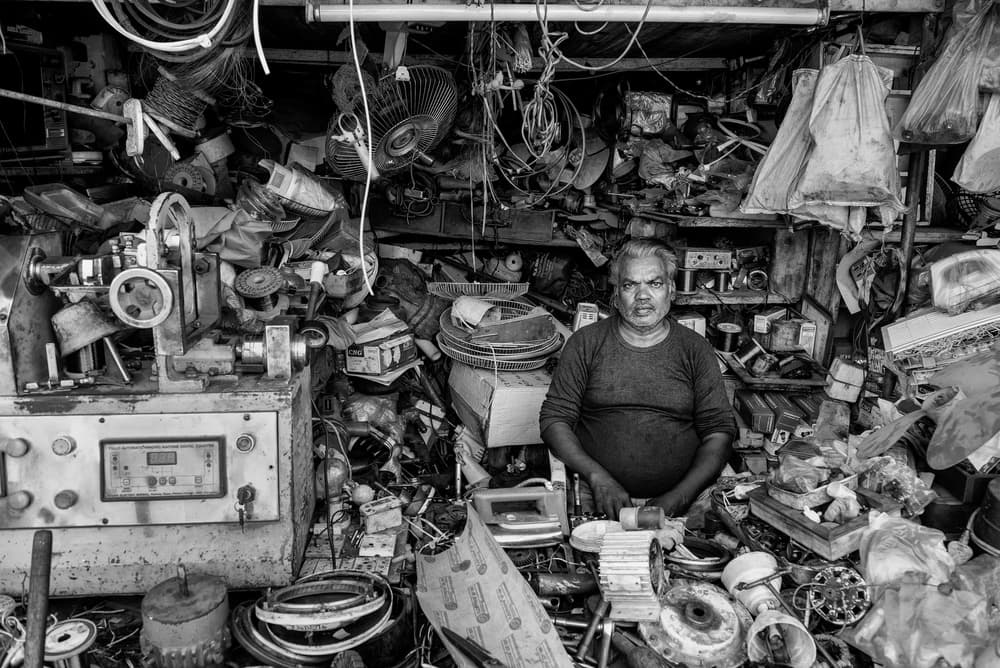 Man In Repair Shop by Andrei Nicolas - The Traveler — canvas wall art