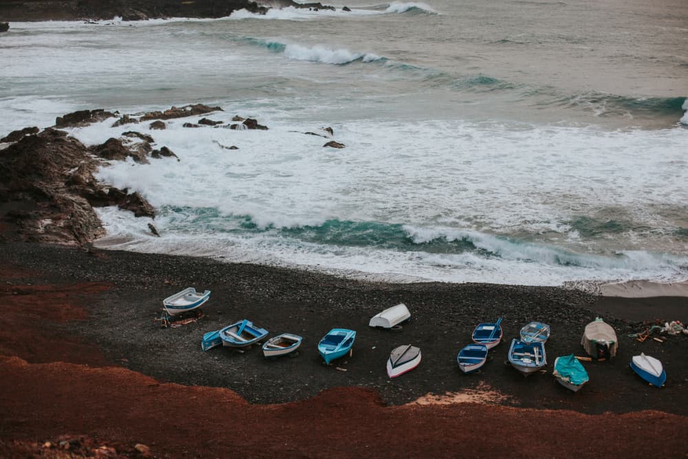 Boats on a Rocky Shore by Claudia Casal — canvas wall art