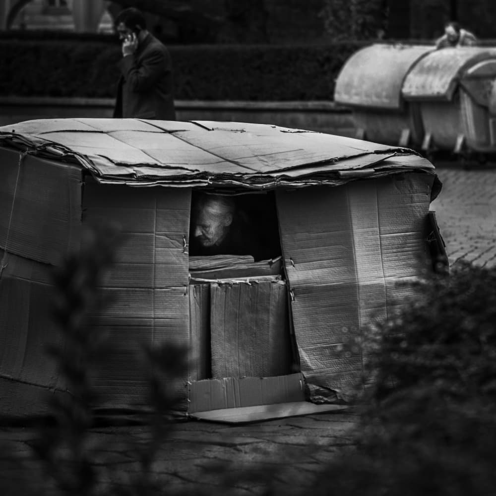 Man in Cardboard Shelter by Bobby Kostadinov — canvas wall art