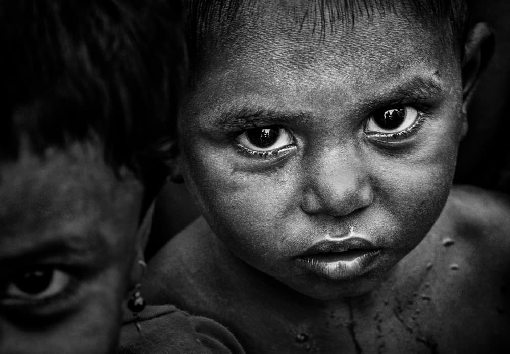 Young Boy's Intense Gaze by Joxe Inazio Kuesta Garmendia — canvas wall art