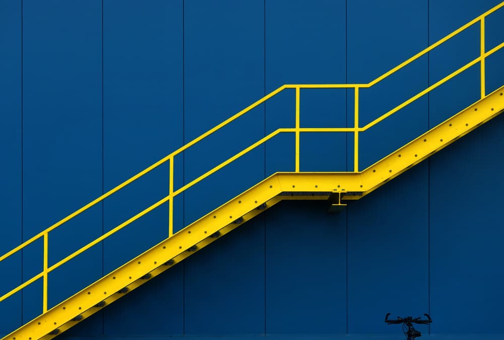 Bold Yellow Stairs Blue Wall by Hans-Wolfgang Hawerkamp — canvas wall art