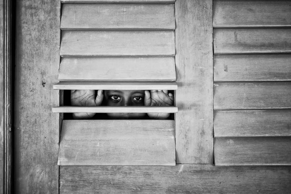 Child Peeking Through Shutters by Gloria Salgado Gispert — canvas wall art