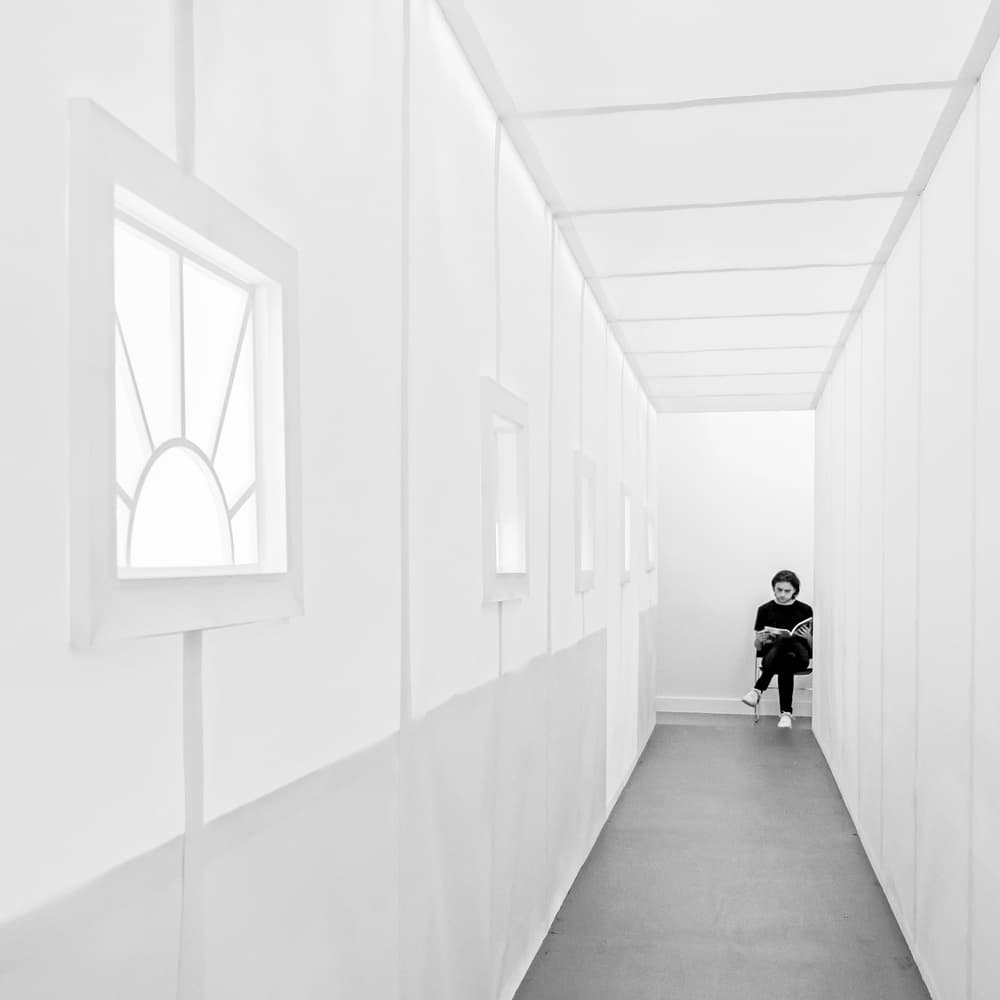 Woman Reading White Hallway by Lus Joosten — canvas wall art