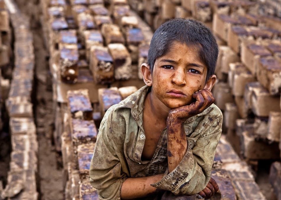 Somber Boy Among Bricks by Mohammadreza Momeni — canvas wall art