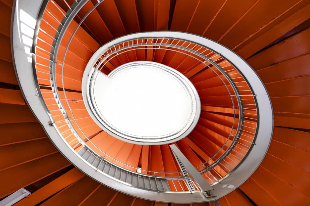 Vibrant Orange Spiral Staircase by Tomoshi Hara — canvas wall art
