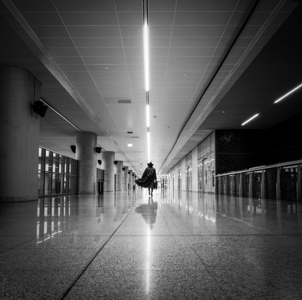Lone Figure Long Hallway by Magdalena Roeseler — canvas wall art