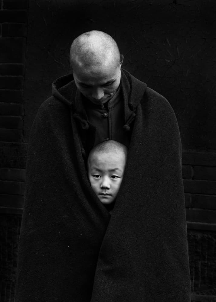 Monk Sheltering A Child by Dennis Zhang — canvas wall art