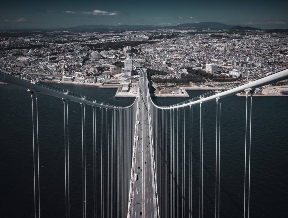 Suspension Bridge Cityscape by Tomoshi Hara — canvas wall art