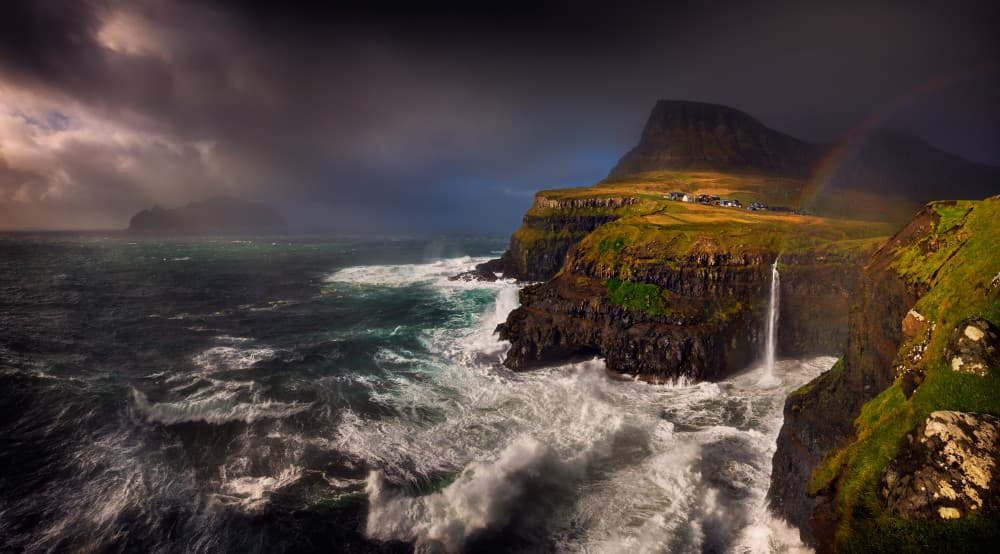 Dramatic Coastal Village Waterfall by Krzysztof Browko — canvas wall art