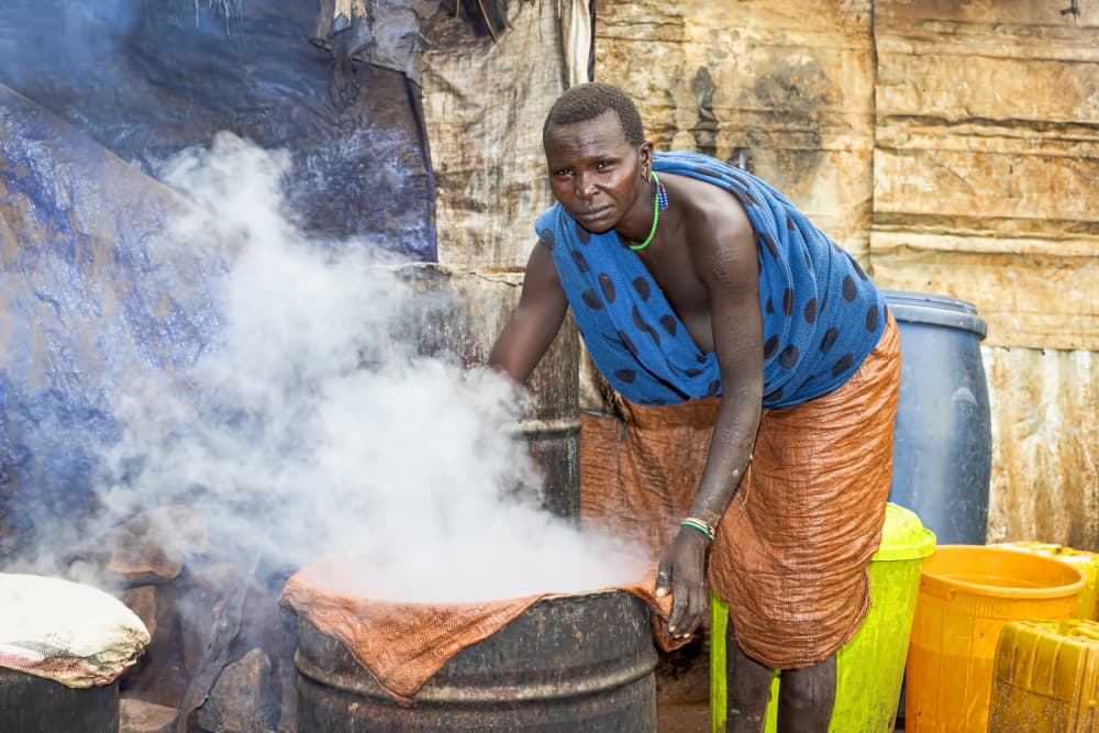 African Woman Steaming Pot by Iris Wiener — canvas wall art
