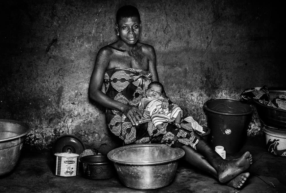 Woman and her chil in their home - Benin by Joxe Inazio Kuesta Garmendia — canvas wall art
