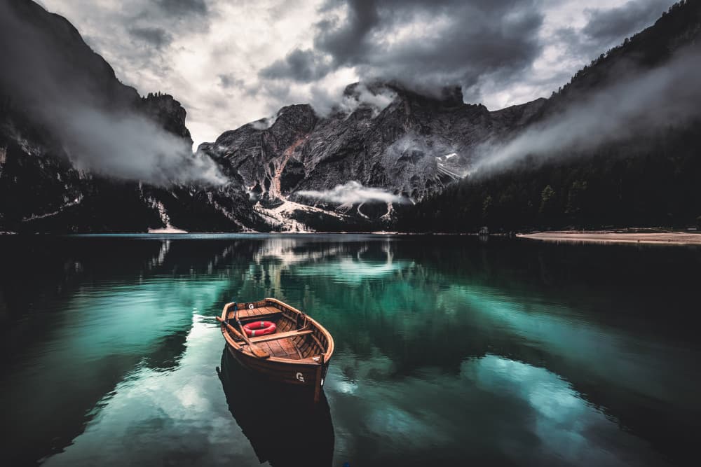 Moody Mountain Lake Boat by Marco Tagliarino — canvas wall art