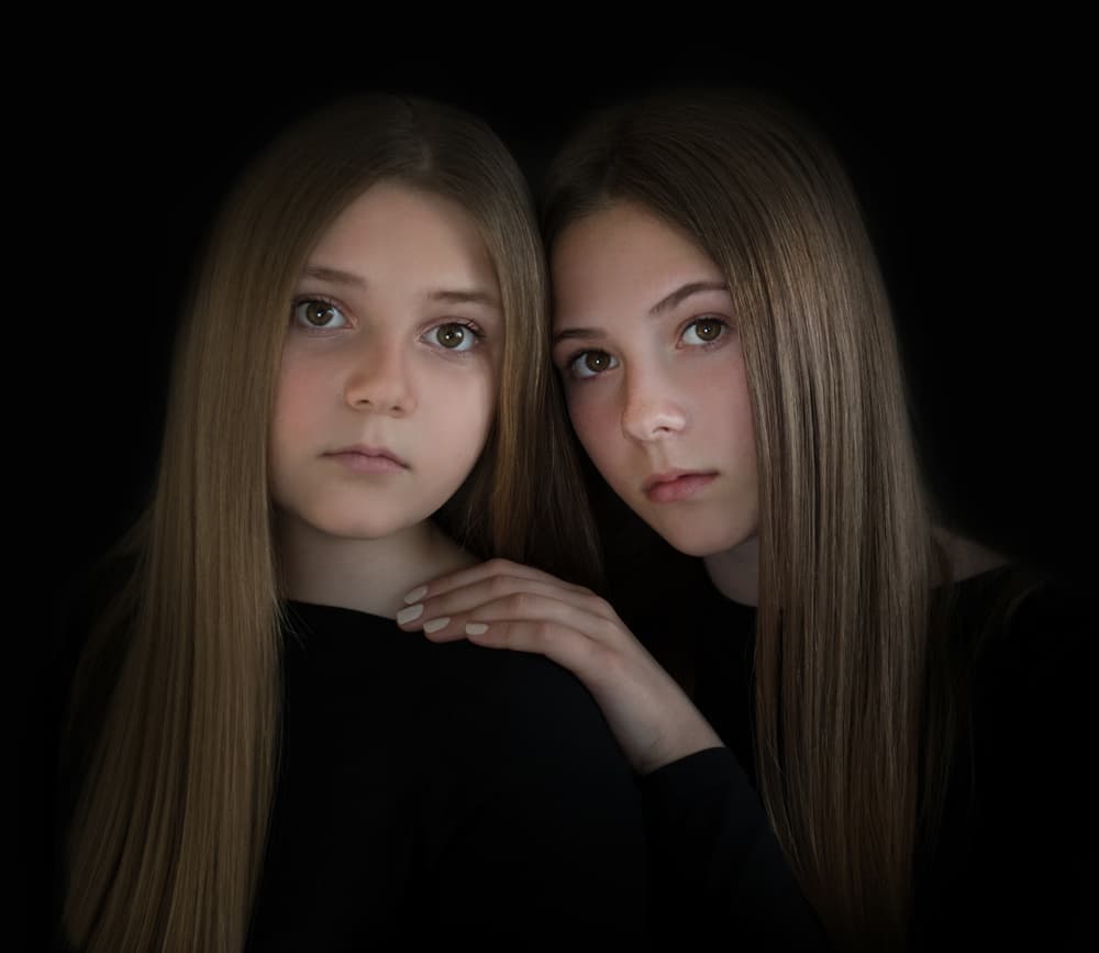 Contemplative Young Sisters by Elena Karagyozova — canvas wall art