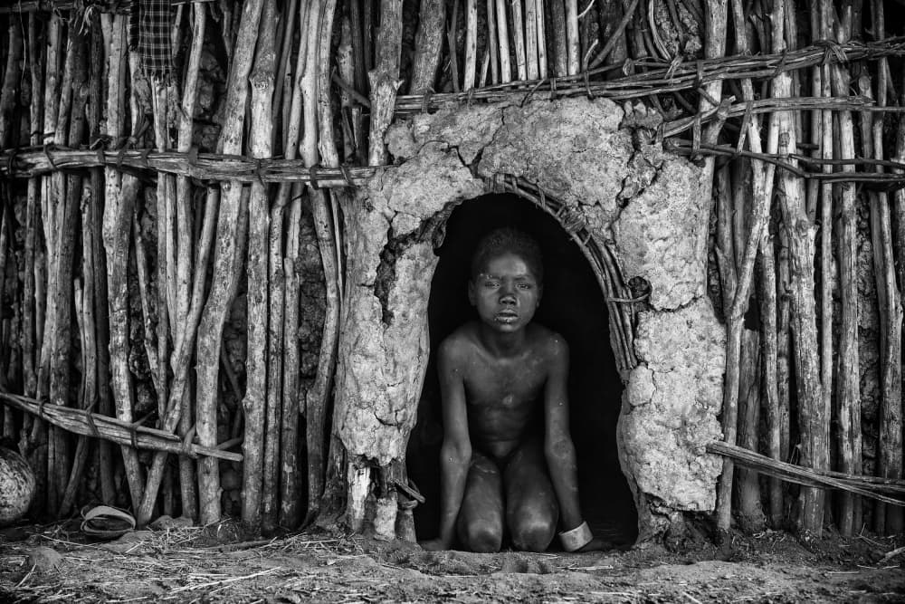 Child in Mud Hut by Goran Jovic — canvas wall art