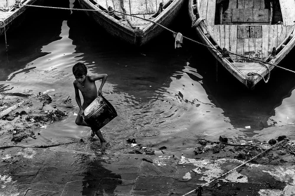 Boy Collecting River Water by Eyal Amer — canvas wall art