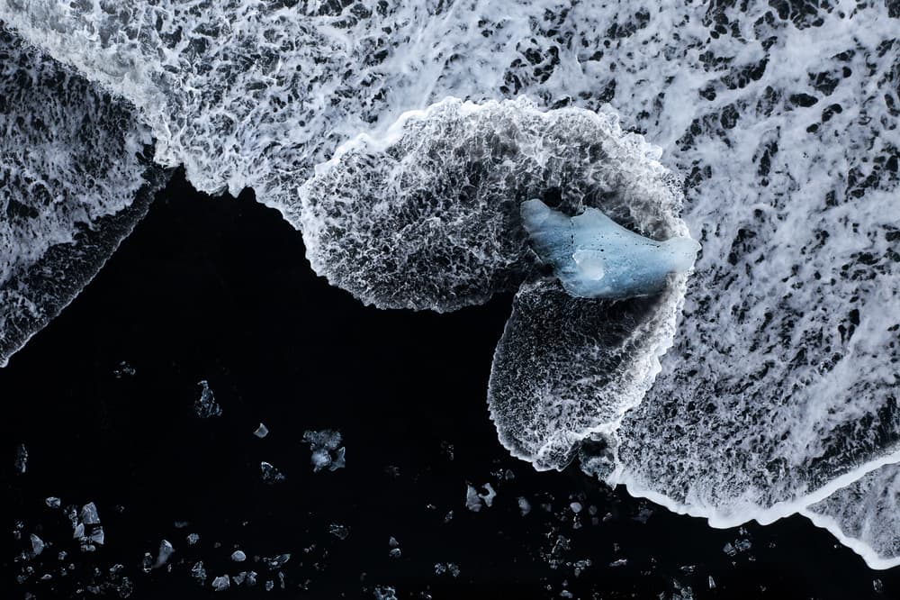 Blue Ice on Black Beach by John Fan — canvas wall art