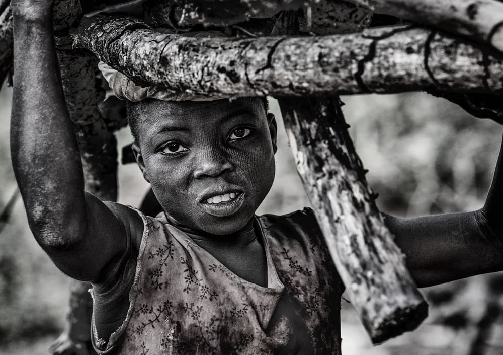 African Child Carrying Wood by Joxe Inazio Kuesta Garmendia — canvas wall art