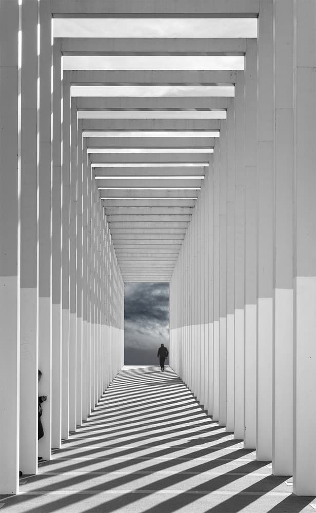 Shadowed Corridor Lone Figure by Uschi Hermann — canvas wall art