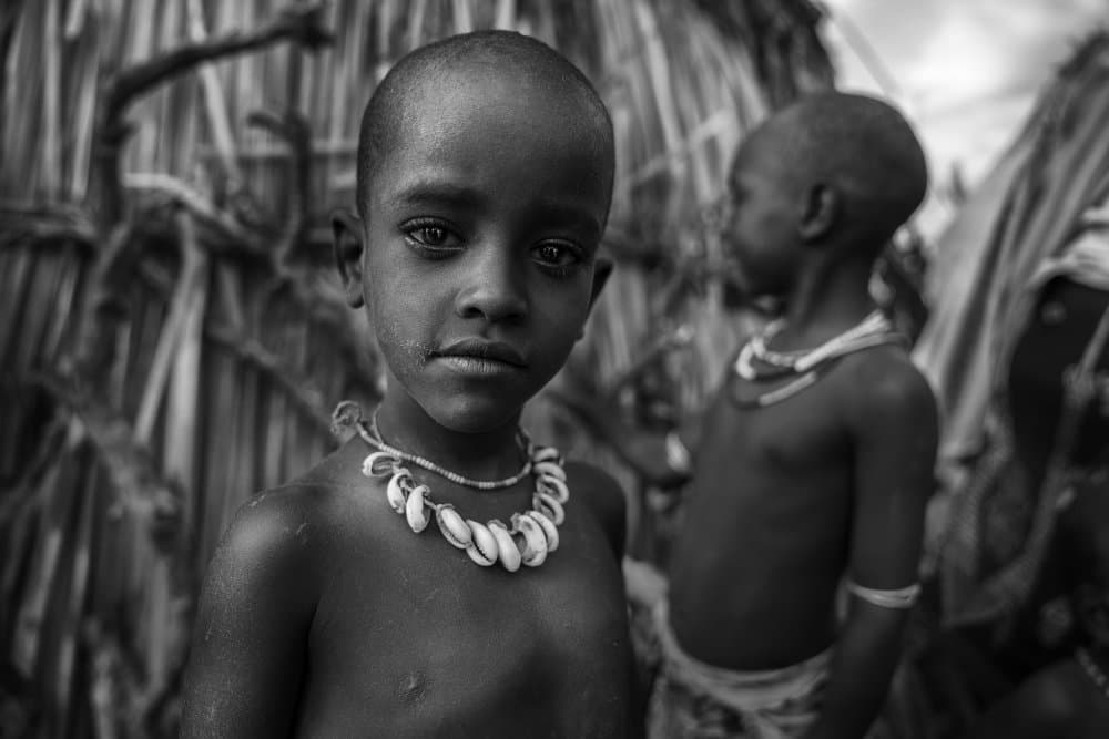 African Child's Gaze by Sarawut Intarob — canvas wall art