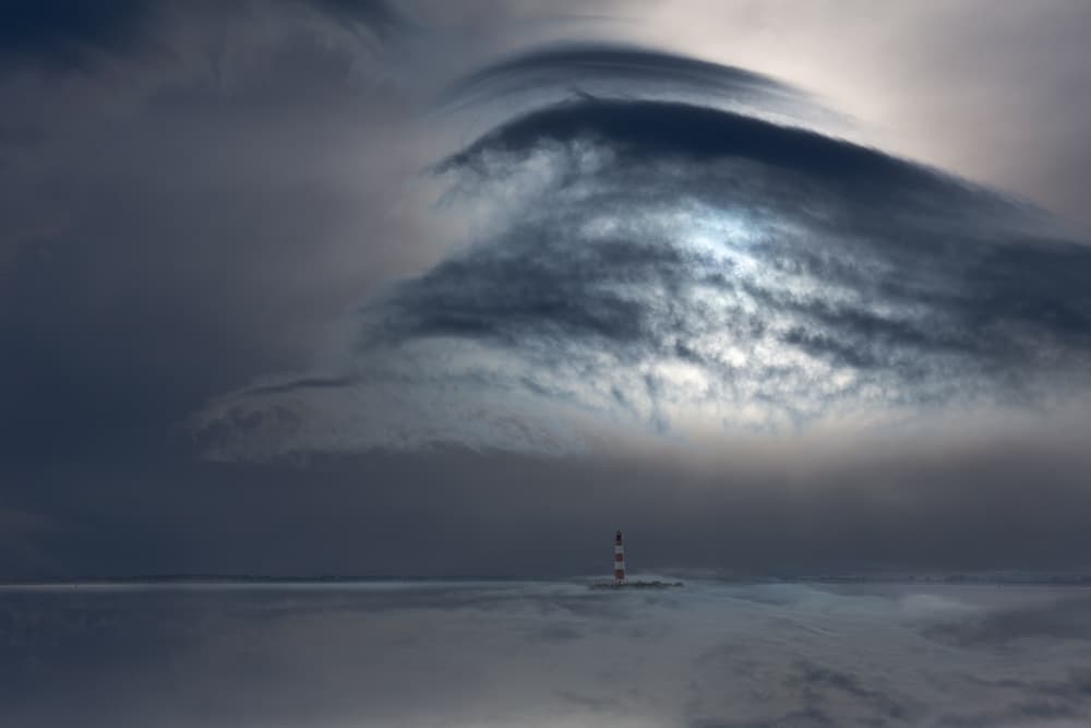 Lighthouse Under Dramatic Sky by Uschi Hermann — canvas wall art