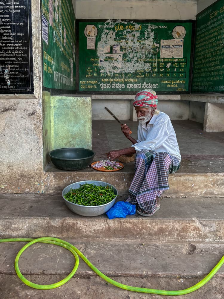 Indian Man Prepping Vegetables by Ilana Lam — canvas wall art