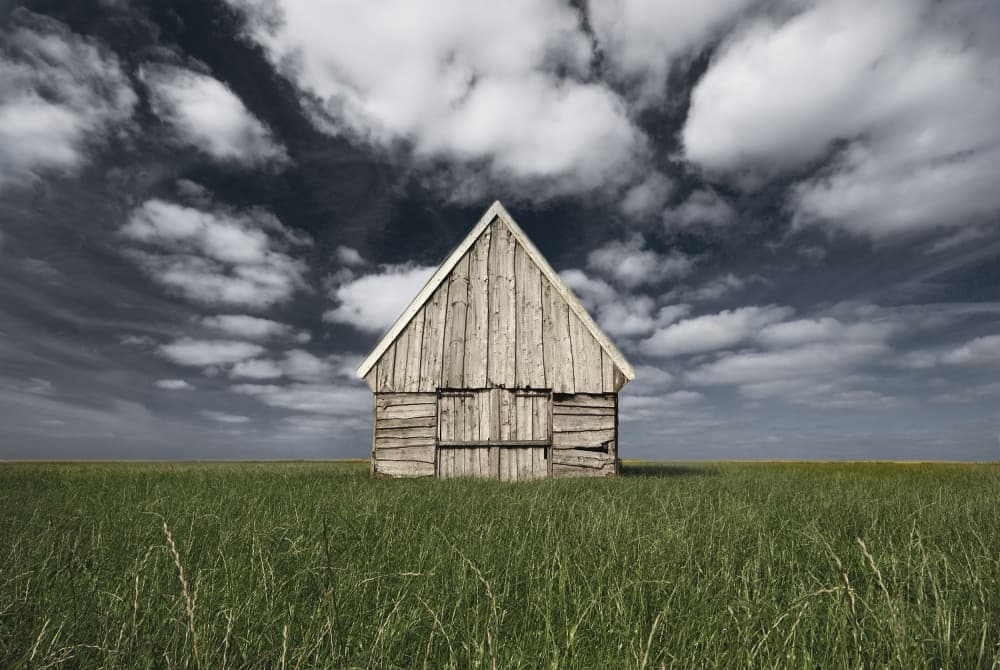 Solitary Barn Under Cloudy Sky by Leon — canvas wall art