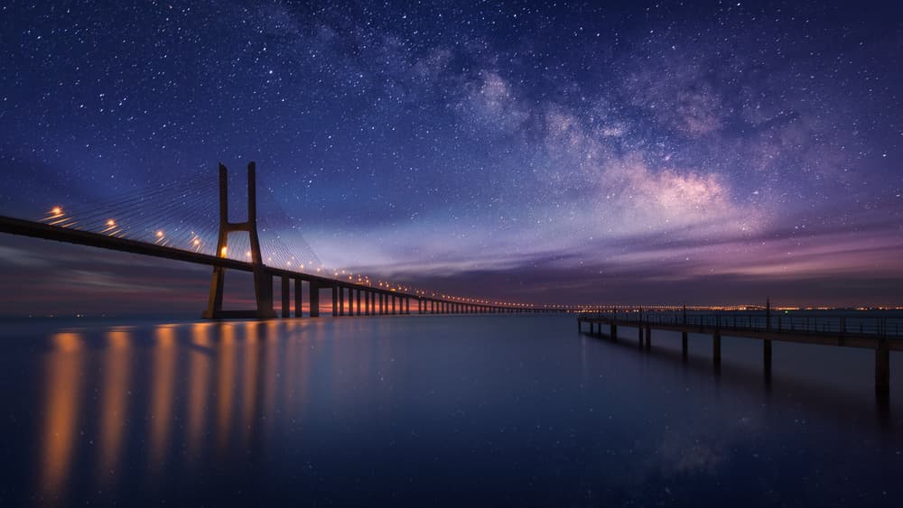 Bridge Under Starry Sky by Carlos F. Turienzo — canvas wall art