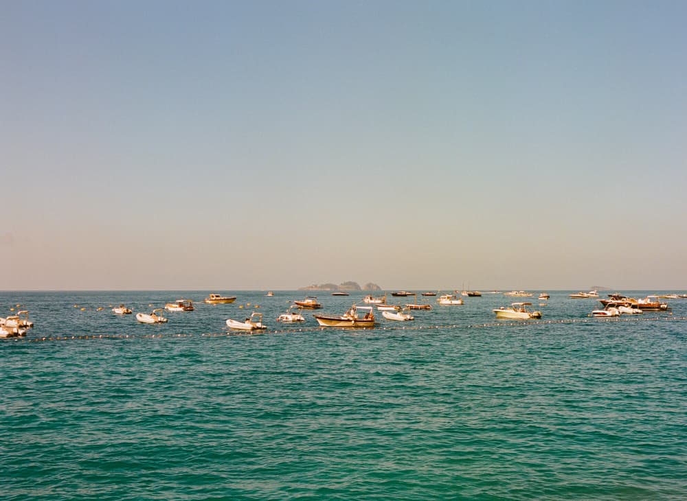 Boats on Calm Blue Sea by Bethany Young — canvas wall art