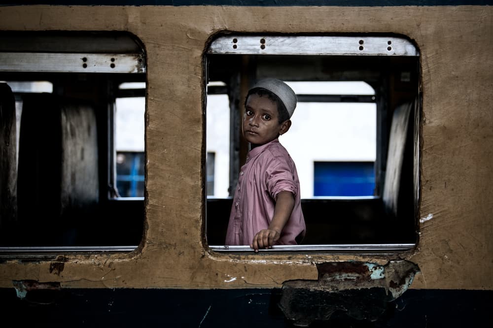 Boy alone in a train carriage - Bangladesh by Joxe Inazio Kuesta Garmendia — canvas wall art