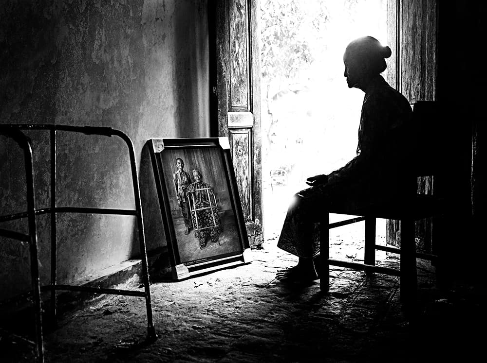 Elderly Woman Reflects by Sebastian Kisworo — canvas wall art