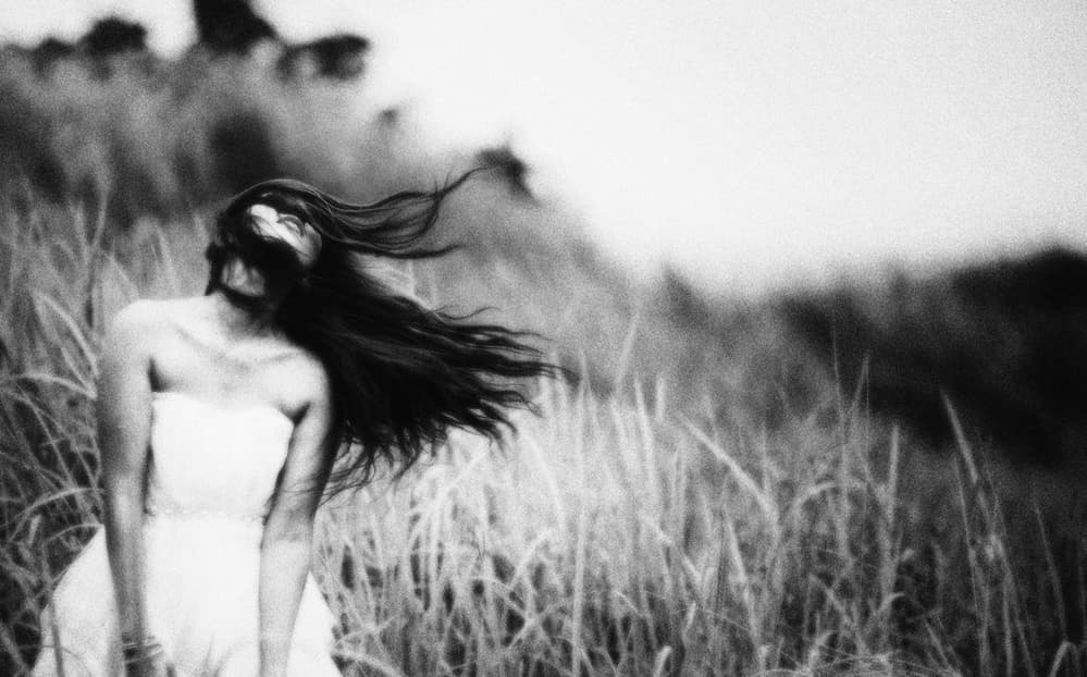 Windswept Woman in Grass by Hari Sulistiawan — canvas wall art