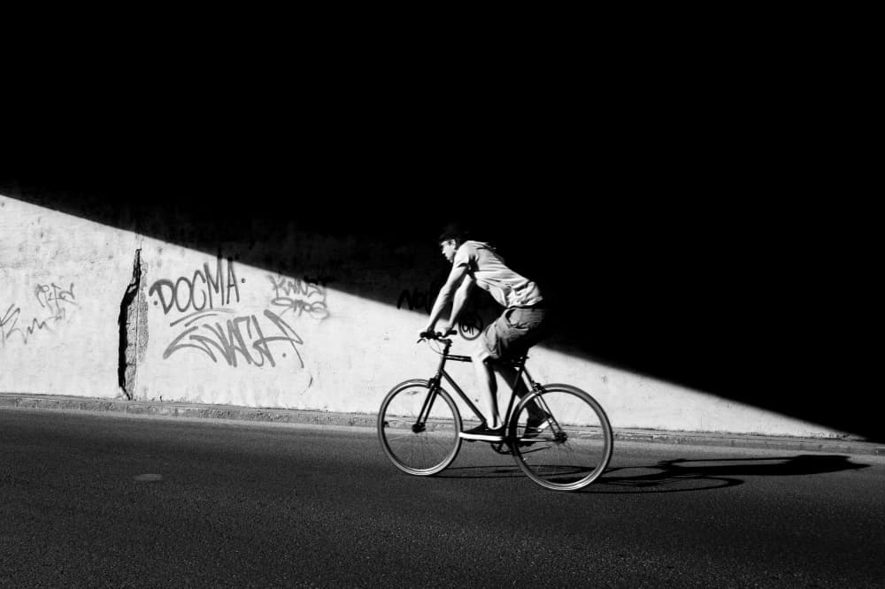 Urban Cyclist Dramatic Light by Tamas Dragon — canvas wall art