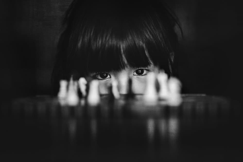 Child's Chess Gaze by Despird Zhang — canvas wall art