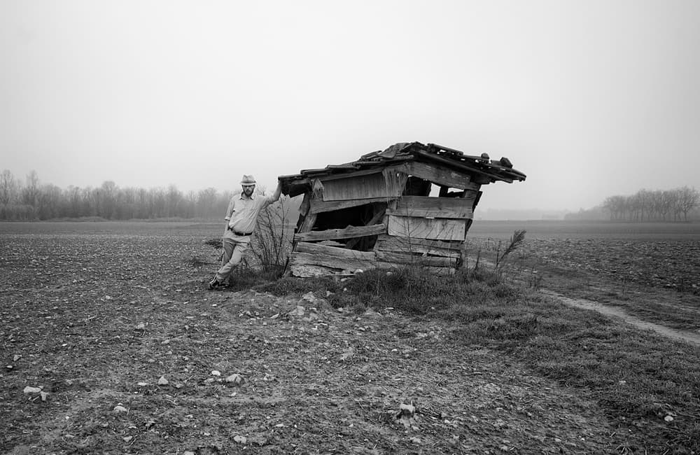 Man Leaning Rustic Shack by Carlo Ferrara — canvas wall art