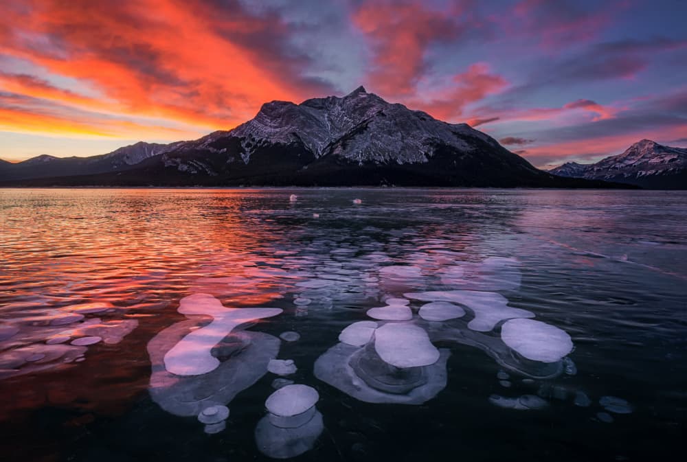 Frozen Lake Sunset Bubbles by Lydia Jacobs — canvas wall art