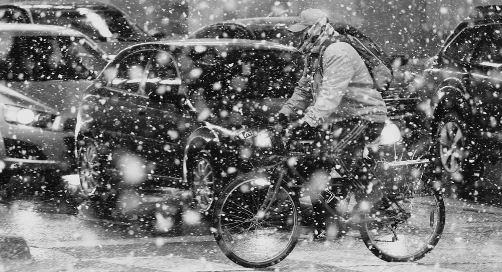 Snowy City Cyclist by Jian Wang — canvas wall art