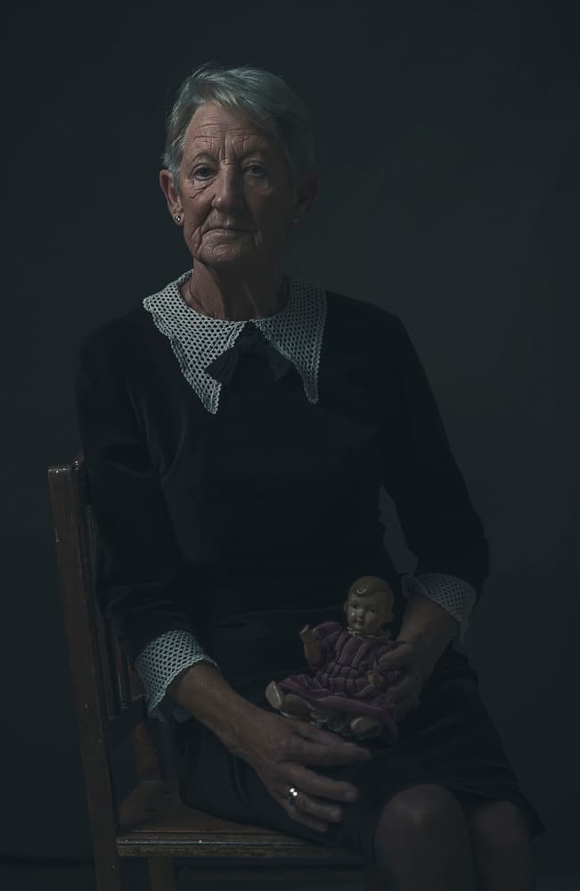 Pensive Woman Holding Doll by Ewa Cwikla — canvas wall art
