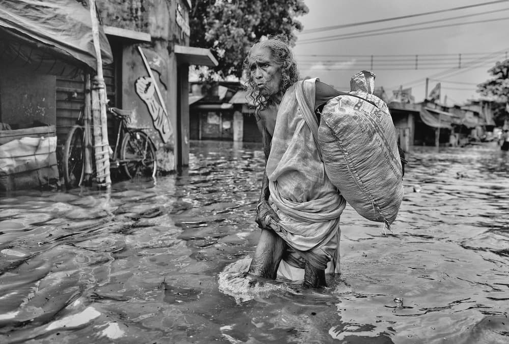 Elderly Woman Flood Journey by Avishek Das — canvas wall art