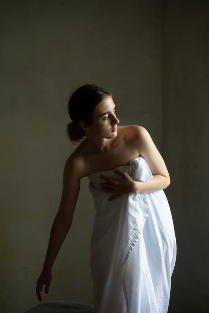 Pensive Woman in White by Małgorzata Masarz — canvas wall art